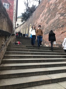 People on the steep stairs in Prague