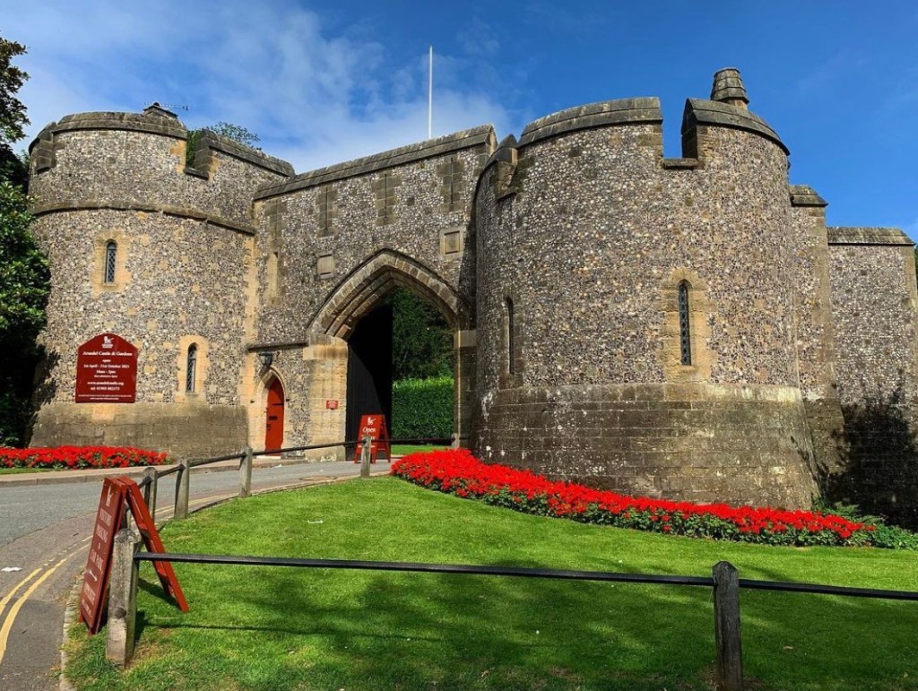 Castle with red flowers around the base. Arundel. 