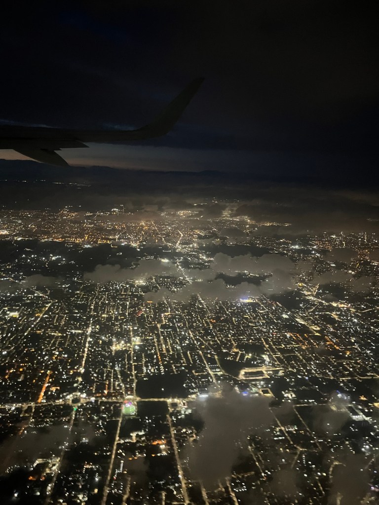 Lots of lights below a plane view of Naples. 